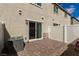 Exterior patio featuring stone pavers, an AC unit, sliding glass doors, and a white fence at 5615 Distelrath Ave, Las Vegas, NV 89122