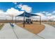 Community playground with sunshade and bench seating, backed by mountain views at 5615 Distelrath Ave, Las Vegas, NV 89122