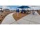 Community playground features covered play structure, benches, and walkways for residents' enjoyment at 5615 Distelrath Ave, Las Vegas, NV 89122