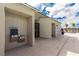 Community pool area with a water fountain, gate, and covered seating area surrounded by desert landscape at 5615 Distelrath Ave, Las Vegas, NV 89122