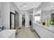 Large, bright bathroom featuring a glass-door shower and dual vanities at 5812 Shangri La Night Ct, Las Vegas, NV 89149