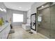 Bright bathroom featuring a glass-door shower, soaking tub, and double vanity at 5812 Shangri La Night Ct, Las Vegas, NV 89149