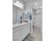 Clean and modern bathroom with double sinks and neutral tile at 5812 Shangri La Night Ct, Las Vegas, NV 89149