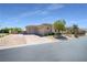 Spacious home featuring a multi-car garage and brick driveway with manicured landscaping at 5812 Shangri La Night Ct, Las Vegas, NV 89149