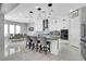 Modern kitchen featuring an island with bar seating, stainless steel appliances, and sleek white cabinetry at 5812 Shangri La Night Ct, Las Vegas, NV 89149