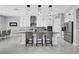Modern kitchen featuring an island with bar seating, stainless steel appliances, and sleek white cabinetry at 5812 Shangri La Night Ct, Las Vegas, NV 89149