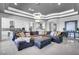 Large sectional sofa in a bright living room with an open kitchen view at 5812 Shangri La Night Ct, Las Vegas, NV 89149
