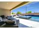 Outdoor oasis featuring a sparkling pool and covered seating area at 5812 Shangri La Night Ct, Las Vegas, NV 89149
