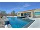 Gorgeous pool area with a modern design, tiled accents, and seamless connection to the home's patio at 5812 Shangri La Night Ct, Las Vegas, NV 89149