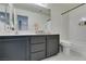 Stylish bathroom showcasing a gray vanity, white countertops, and a shower-tub combination at 6220 Silver Edge St, North Las Vegas, NV 89031