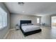 Bright bedroom featuring wood-look floors, neutral tones, and large windows for plenty of light at 6220 Silver Edge St, North Las Vegas, NV 89031