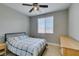 Cozy bedroom with a ceiling fan and a bright window that allows natural light to fill the space at 6220 Silver Edge St, North Las Vegas, NV 89031