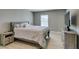 Cozy bedroom with neutral tones, wood-look floors, and a comfortable queen-sized bed at 6220 Silver Edge St, North Las Vegas, NV 89031