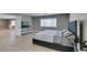Generously sized bedroom boasting wood-look floors, natural light, and gray decor at 6220 Silver Edge St, North Las Vegas, NV 89031