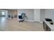 Bonus room featuring wood-look floors and a view to the staircase and secondary bedroom at 6220 Silver Edge St, North Las Vegas, NV 89031