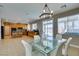 Dining area with a glass table set, open to the kitchen with wood cabinets and stainless steel appliances at 6220 Silver Edge St, North Las Vegas, NV 89031