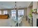 Bright dining area features a glass table set and modern light fixture, ideal for Gathering meals and entertaining at 6220 Silver Edge St, North Las Vegas, NV 89031