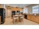 Functional kitchen with wood cabinets, stainless steel appliances, and an island with bar seating for casual dining at 6220 Silver Edge St, North Las Vegas, NV 89031