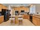 Kitchen featuring an island with seating, stainless steel appliances, and ample wood cabinets for storage at 6220 Silver Edge St, North Las Vegas, NV 89031