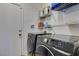 Well-equipped laundry room with modern washer and dryer, along with practical shelving for storage at 6220 Silver Edge St, North Las Vegas, NV 89031