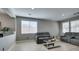 Cozy living room with comfortable seating and bright natural light from the large windows at 6220 Silver Edge St, North Las Vegas, NV 89031