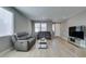 Well-lit living room with dual sofas, large television, and a neutral color scheme at 6220 Silver Edge St, North Las Vegas, NV 89031