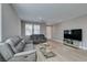 Spacious living room with comfortable sofas, modern decor, and ample natural light at 6220 Silver Edge St, North Las Vegas, NV 89031