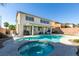 Inviting backyard pool and spa with outdoor lounge area is perfect for entertaining and relaxing at 6220 Silver Edge St, North Las Vegas, NV 89031