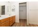 Bathroom featuring a double sink vanity with wood cabinets, and a walk-in closet with shelving at 6700 Amarinta Ave # 104, Las Vegas, NV 89108