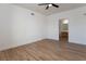 Spacious bedroom featuring wood floors, ceiling fan, and ensuite bath access, perfect for relaxation at 6700 Amarinta Ave # 104, Las Vegas, NV 89108