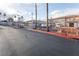 The community gated entrance, featuring mature palm trees and manicured landscaping at 6700 Amarinta Ave # 104, Las Vegas, NV 89108