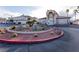Community building entrance featuring desert landscaping, covered entry, and ample parking at 6700 Amarinta Ave # 104, Las Vegas, NV 89108
