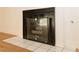 A close-up of the fireplace with tiled base and hearth, a standout feature of this cozy living space at 6700 Amarinta Ave # 104, Las Vegas, NV 89108