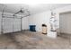Spacious garage with a white garage door, water heater, and storage space at 6700 Amarinta Ave # 104, Las Vegas, NV 89108