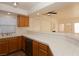 Open concept kitchen with tile countertops and access to the living room, ideal for entertaining guests at 6700 Amarinta Ave # 104, Las Vegas, NV 89108