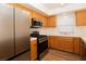 Modern kitchen boasts stainless steel appliances, wooden cabinetry, and bright natural light for a pleasant cooking experience at 6700 Amarinta Ave # 104, Las Vegas, NV 89108