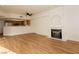 Bright living room with modern fireplace, wood floors, ceiling fan, and kitchen view for easy entertaining at 6700 Amarinta Ave # 104, Las Vegas, NV 89108