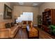 Inviting living room area with comfortable leather seating, shelving, and decorations at 6700 Amarinta Ave # 104, Las Vegas, NV 89108