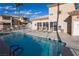Sparkling pool surrounded by lounging chairs and lush landscaping at 6700 Amarinta Ave # 104, Las Vegas, NV 89108
