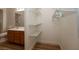 Close-up of a walk-in closet with white shelving and ample storage space in a clean, white room at 6700 Amarinta Ave # 104, Las Vegas, NV 89108