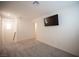 Bedroom with neutral carpet, TV, and staircase leading up to the second floor at 6913 Evening Orchid St, North Las Vegas, NV 89086