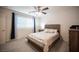 Bright bedroom featuring neutral walls, carpeted floors, and modern ceiling fan at 6913 Evening Orchid St, North Las Vegas, NV 89086