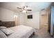 Well-lit bedroom featuring neutral walls, carpeted floors and view into ensuite at 6913 Evening Orchid St, North Las Vegas, NV 89086