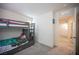 Bedroom showcasing a bunk bed, carpet flooring, and access to the hallway at 6913 Evening Orchid St, North Las Vegas, NV 89086