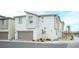 Two-story home features neutral stucco, an attached garage, and low-maintenance landscaping at 6913 Evening Orchid St, North Las Vegas, NV 89086
