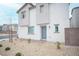 Modern two-story home with xeriscaping featuring a stylish blue front door at 6913 Evening Orchid St, North Las Vegas, NV 89086