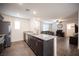 Open kitchen with granite countertops, stainless steel appliances, and a view of the living room at 6913 Evening Orchid St, North Las Vegas, NV 89086