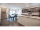 Modern kitchen with sleek countertops, stainless steel appliances, and a dining area at 6913 Evening Orchid St, North Las Vegas, NV 89086