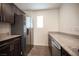 Contemporary kitchen with stainless steel refrigerator, ample counter space and sleek cabinetry at 6913 Evening Orchid St, North Las Vegas, NV 89086