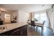 Bright kitchen with granite countertops, stainless steel sink, and adjacent dining space at 6913 Evening Orchid St, North Las Vegas, NV 89086
